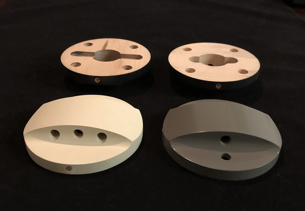Four maple lamp bases, CNC routed and drilled, with black, white, and gray spray finishes.