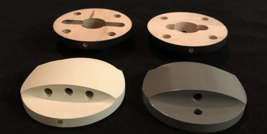 Four maple lamp bases, CNC routed and drilled, with black, white, and gray spray finishes.