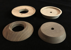 Four turned lamp bases in white birch and walnut, routed, drilled, and sanded for smooth finish.
