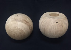 Two 7.5 inch white oak wood balls, drilled and sanded, ready for finishing.