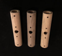 Three turned wood lighting tubes with precision-drilled holes, designed for custom lighting applications.