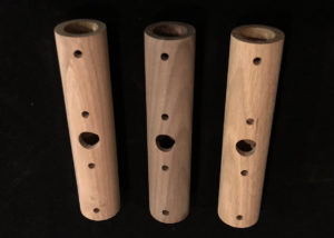 Three turned wood lighting tubes with precision-drilled holes, designed for custom lighting applications.