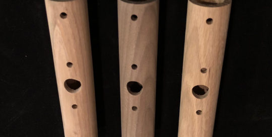 Three turned wood lighting tubes with precision-drilled holes, designed for custom lighting applications.