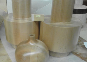 Large turned soft maple lamp bases with a clear finish, produced as samples for a commercial lighting manufacturer.