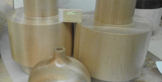 Large turned soft maple lamp bases with a clear finish, produced as samples for a commercial lighting manufacturer.