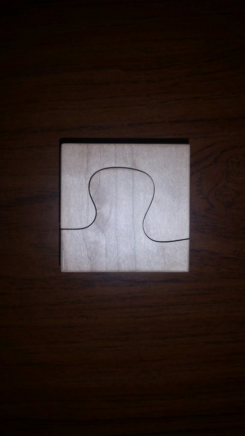 Puzzle-shaped lamp base that was CNC machined from soft maple wood.