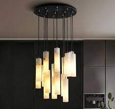 Ceiling-mounted alabaster chandelier with multiple hanging pendant lights in staggered lengths.