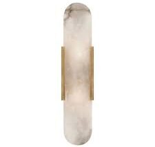 Alabaster wall sconce with rounded edges and brass hardware for luxury lighting design.