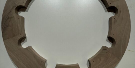 CNC-routed walnut ring assembled with Festool domino joinery and precision-drilled cutouts.
