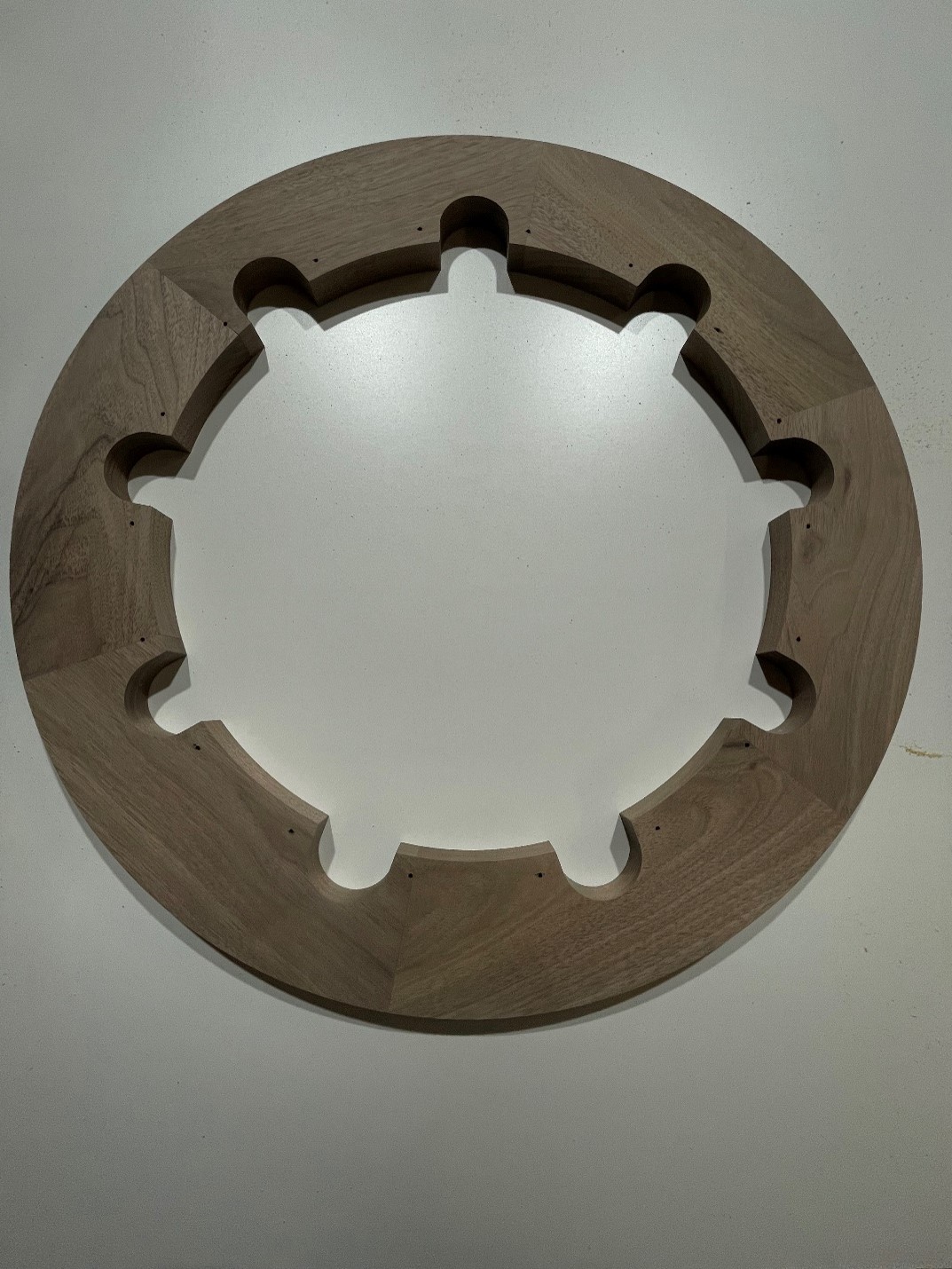 CNC-routed walnut ring assembled with Festool domino joinery and precision-drilled cutouts.