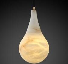 Teardrop-shaped alabaster pendant light with smooth matte finish and soft internal glow.