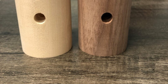 Turned wood lighting components in walnut and hard maple with center bore and side hole.